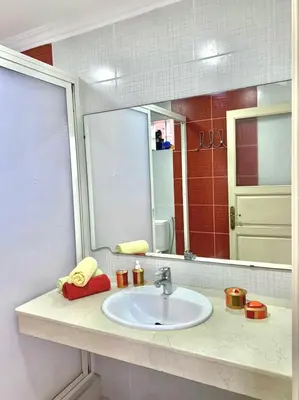 a bathroom with a sink and a mirror at L'Oasis Villa in Marrakech
