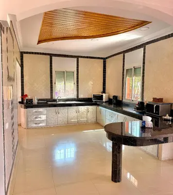 a large kitchen with a table in a room at L'Oasis Villa in Marrakech