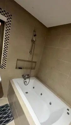 a white tub in a bathroom with a shower at Prestigia luxury home in Fès