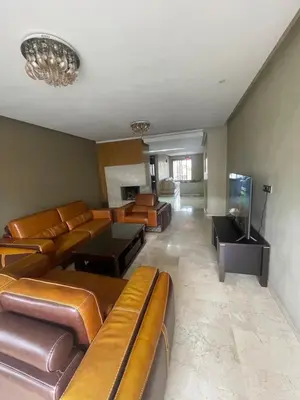 a large living room with couches and a tv at Prestigia luxury home in Fès
