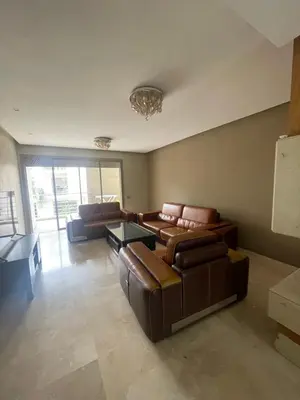 a living room with two leather couches and a table at Prestigia luxury home in Fès