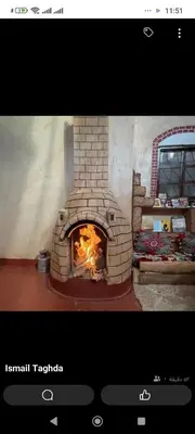 a brick oven with a fire inside of it at Dar Laayoune in Kalaat MGouna