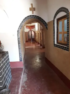 an alley with water in a building with a cross on the wall at Dar Laayoune in Kalaat MGouna