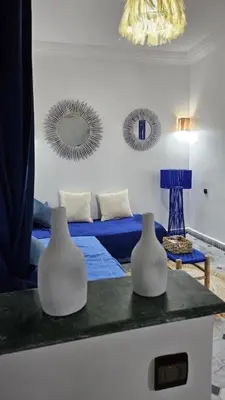 two white vases sitting on a counter in a living room at La kasbah bleue in Marrakech