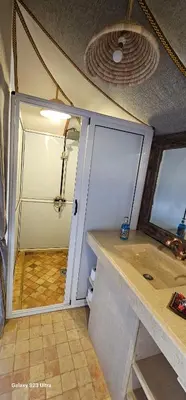 a garage with a door and a counter in a room at Luxury Nomadic Tented Camp in Merzouga