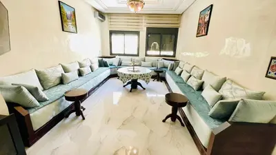 a living room with a long couch and a table at welcome to fez in Fès
