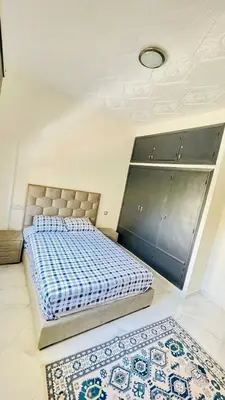 a bedroom with a bed and two rugs on the floor at welcome to fez in Fès