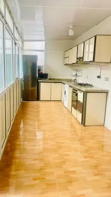an empty kitchen with a wooden floor in a room at welcome to fez in Fès