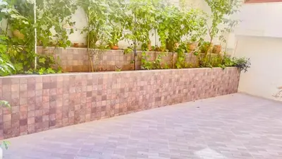 a brick wall with plants on top of it at welcome to fez in Fès
