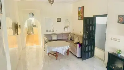 a living room with a couch and a table at welcome to fez in Fès