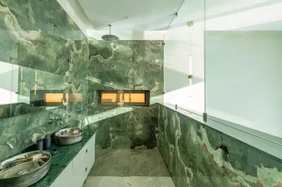a bathroom with two sinks and a stone wall at Villa Seyana master, piscine privée, sans vis à vis in Marrakech