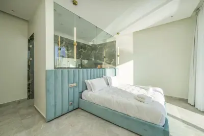 a bedroom with a bed with a blue cabinet at Villa Seyana master, piscine privée, sans vis à vis in Marrakech