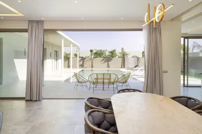 a dining room with a table and chairs at Villa Seyana master, piscine privée, sans vis à vis in Marrakech