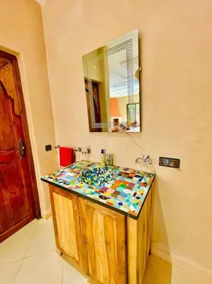 a bathroom with a sink and a mirror at Villa1 des tortues Marrakech in Aït Zat