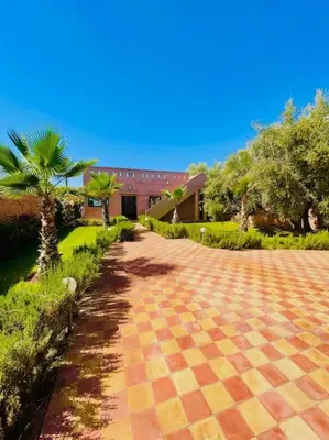 a cobblestone road in front of a building at Villa1 des tortues Marrakech in Aït Zat