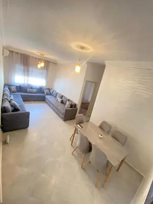 a living room with a couch and a table and chairs at طريق صفرو in Fès