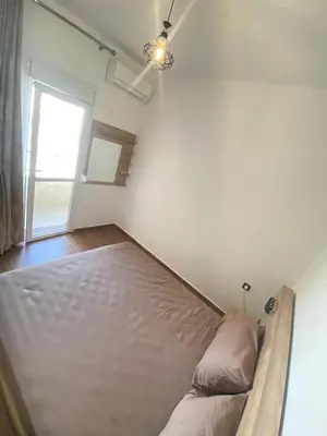 a bed in a room with a window at طريق صفرو in Fès