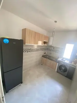a kitchen with a black refrigerator and a stove at طريق صفرو in Fès