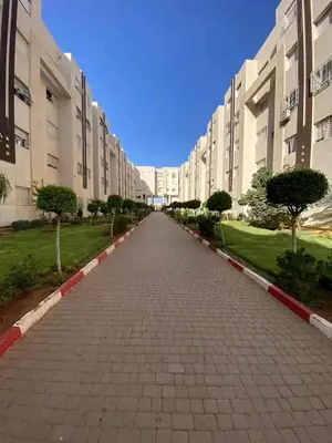 an empty street in front of a large building at طريق صفرو in Fès