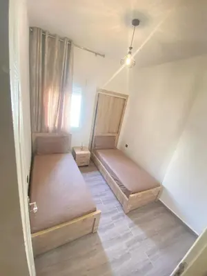 a room with two beds and a window at طريق صفرو in Fès