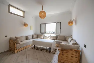 a living room with a couch and a table at Dar Diafa in Merzouga