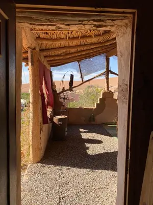 an open door of a building with a view of the desert at Les cavaliers chez Yassine in Marrakech