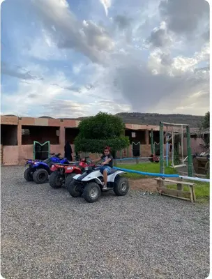 a person sitting on a four wheeler on a playground at Les cavaliers chez Yassine in Marrakech
