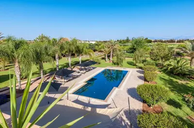 an overhead view of a swimming pool with palm trees at Maidan El Arsa in Marrakech