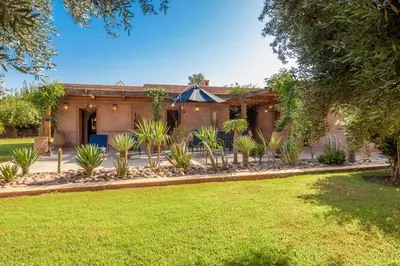 a house with a lot of plants in the yard at Maidan El Arsa in Marrakech