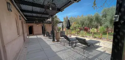 a patio with chairs and a table on a patio at Maidan El Arsa in Marrakech
