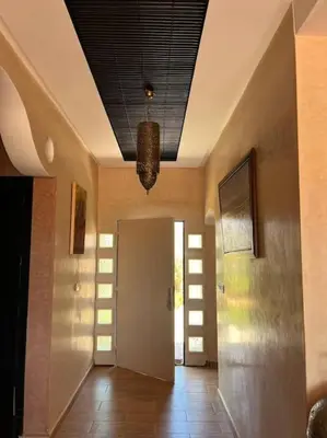 a hallway of a house with a ceiling at belle ferme a louer in Tiflet