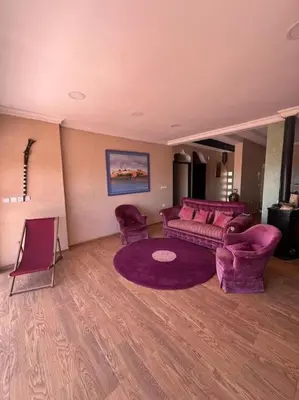 a living room with a couch and two chairs at belle ferme a louer in Tiflet