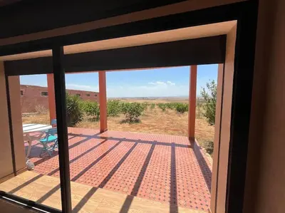 a view from a glass door of a patio at belle ferme a louer in Tiflet