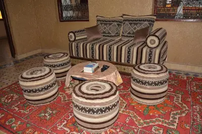 a living room with a couch and a table at Sahara House in Merzouga