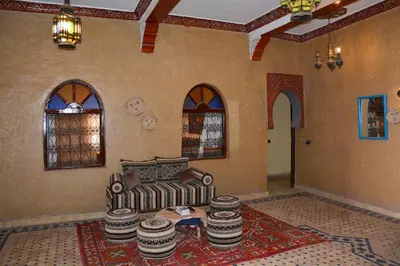 a living room with a couch and a table at Sahara House in Merzouga