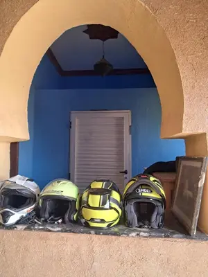 four helmets sitting on a counter in a room at Sahara House in Merzouga