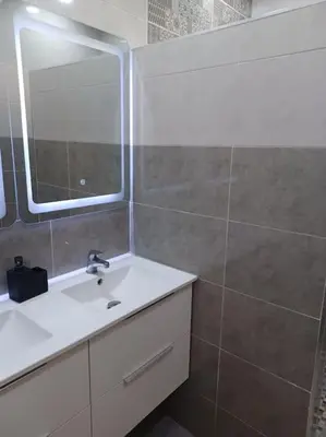 a bathroom with a sink and a mirror at Maison familiale avec piscine privée sans vis à vis in Tarhia