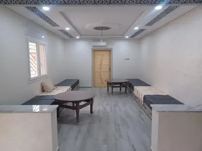 a room with two tables and two benches in it at Maison familiale avec piscine privée sans vis à vis in Tarhia