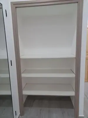 a closet with white shelves in a room at Maison familiale avec piscine privée sans vis à vis in Tarhia