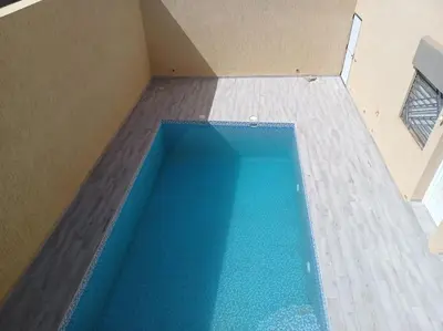 an overhead view of a swimming pool in a house at Maison familiale avec piscine privée sans vis à vis in Tarhia