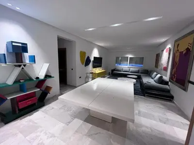 a living room with a couch and a table at Appartement spacieux et luxueux in Fès