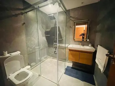 a bathroom with a shower and a toilet and a sink at Appartement spacieux et luxueux in Fès