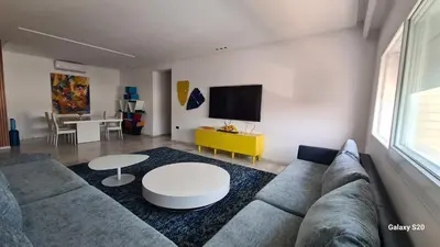 a living room with a couch and a table at Appartement spacieux et luxueux in Fès