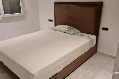 a large white bed in a room at Appartement spacieux et luxueux in Fès