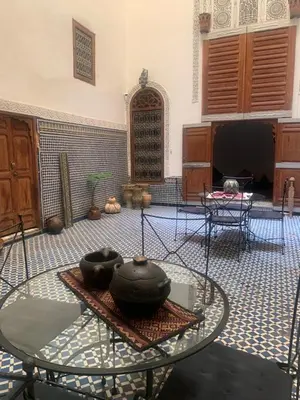 a room with a table with bowls on top of it at Dar Nejma in Fès