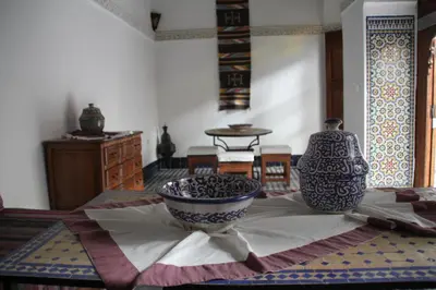 a room with a table with two vases on it at Dar Nejma in Fès