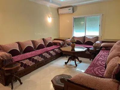 a living room with a couch and a table at Meknes Apartment Oudi in Meknès
