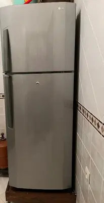 a stainless steel refrigerator sitting in a kitchen at Meknes Apartment Oudi in Meknès