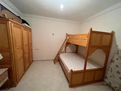 a bedroom with a bunk bed and a cabinet at Meknes Apartment Oudi in Meknès