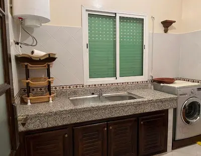 a kitchen with a sink and a washing machine at Meknes Apartment Oudi in Meknès